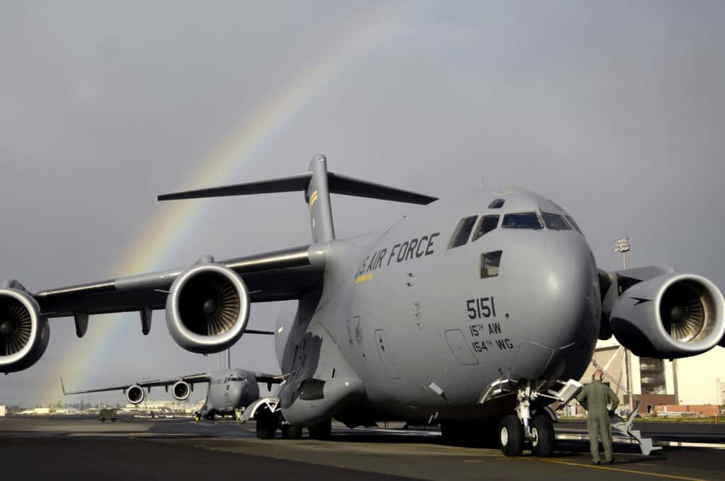 A C-17 with a rainbow in the background. When you take a Space-A flight (mac flight), you may ride in one of these aircraft.