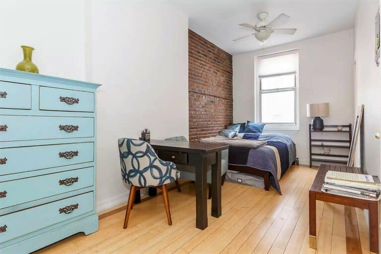An apartement with a light blue dresser