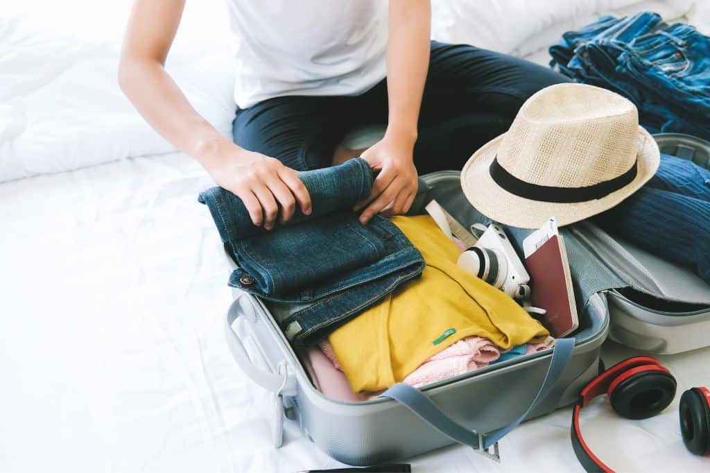 A person packing a suitcase