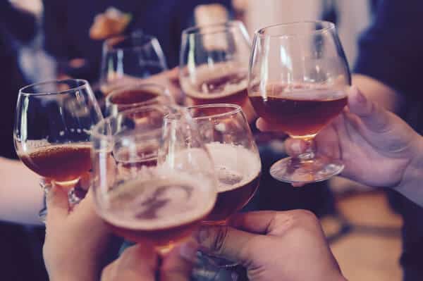 Glasses raised for a toast. Becoming a regular at a bar is a great way to meet locals. while traveling