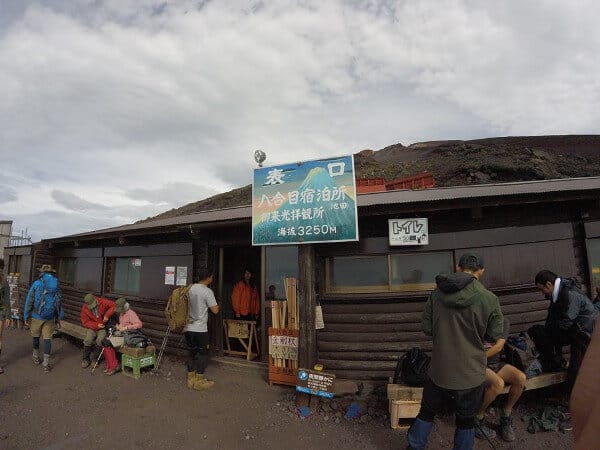 Hikers at a rest stop while climbing Mount Fuji