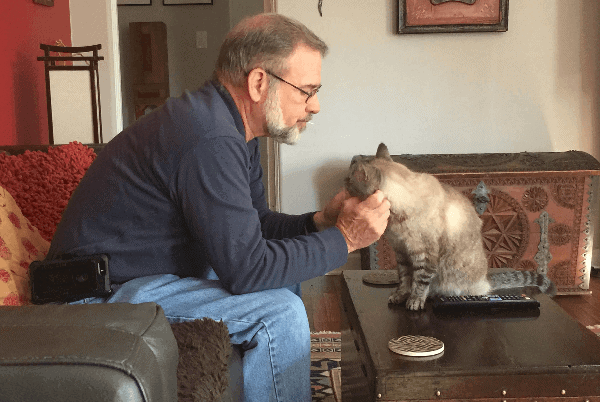 Picture of Kenny petting a cat during a house sit