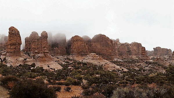 Picture of rock formations surrounded by clouds and mist in Arches National Park