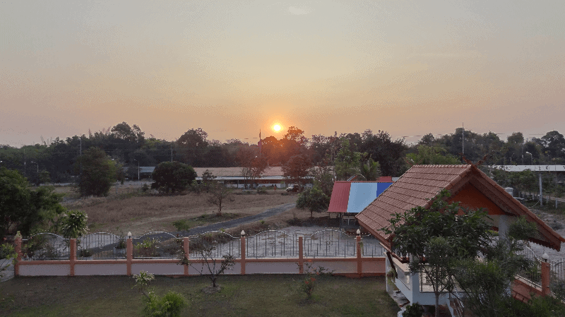 Picture of a sunset over a large property in Thailand
