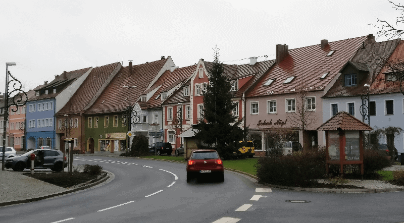 Picture of a car passing in front of a row of traditional German houses in Vilseck, Germany