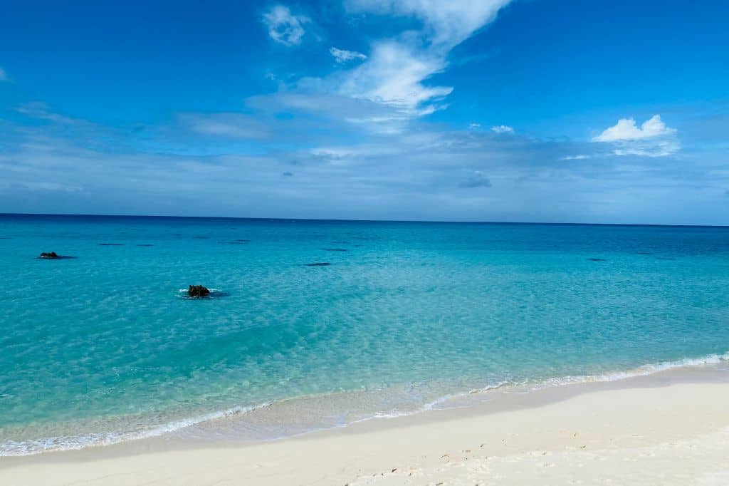 Turquoise water next to a white sand beach in okinawa