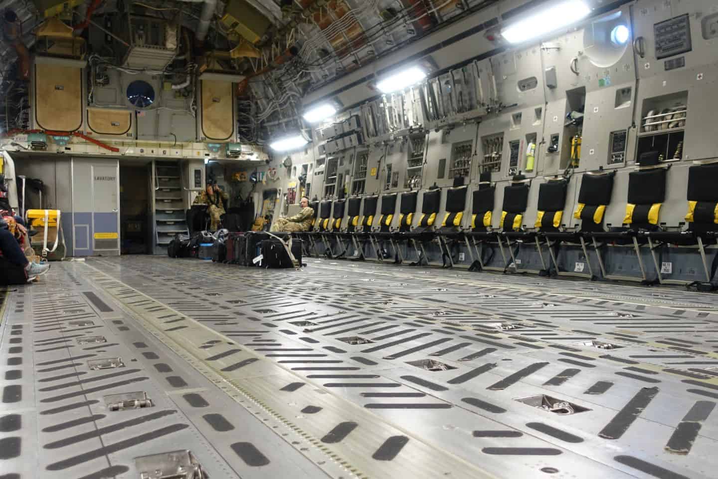 Empty seats along the walls of a military cargo plane