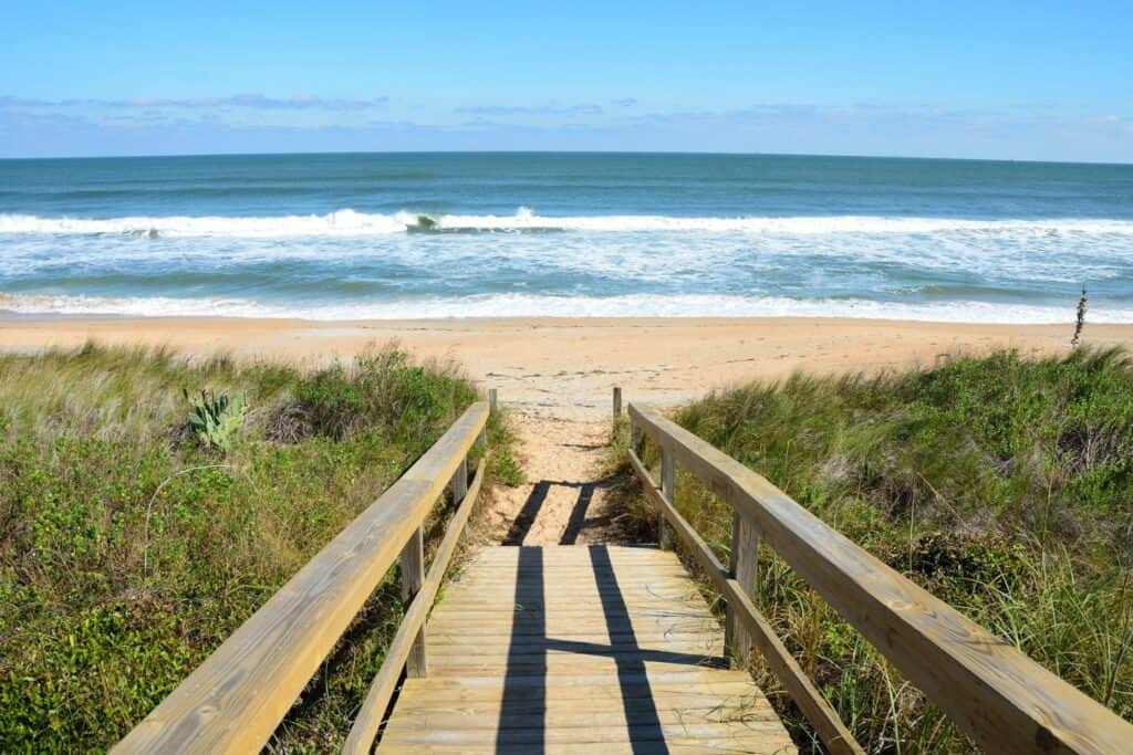 A wooden boardwalk leading to a beach
