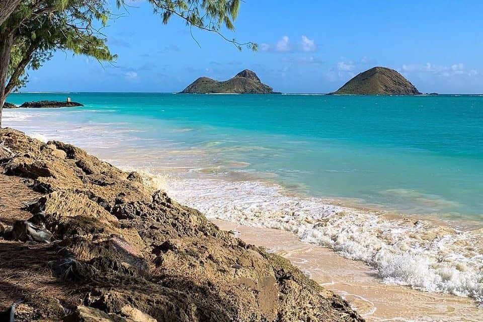 Turquoise water with small islands in the background