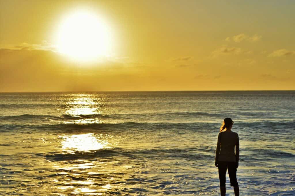 Silhouette of a woman on a beach at sunset