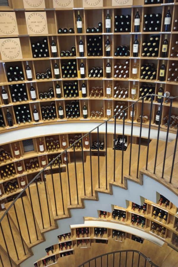 A sprial staircase lined with hundreds of bottles of wine