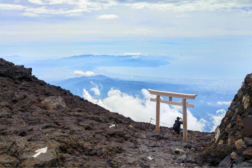 A torii gate with clouds floating in the background