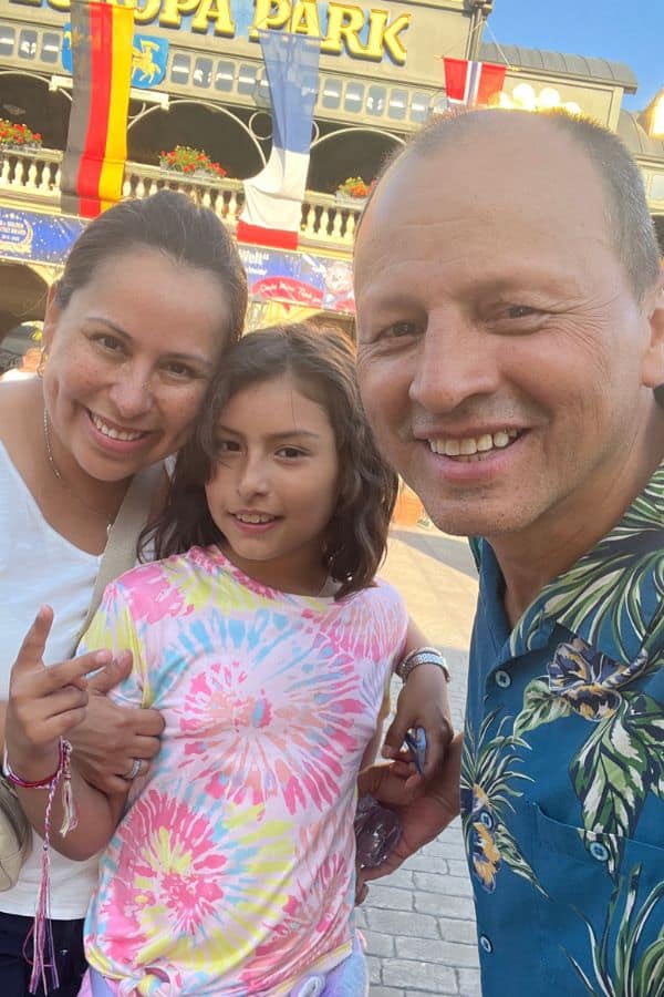 A couple posing for a photo with a young girl