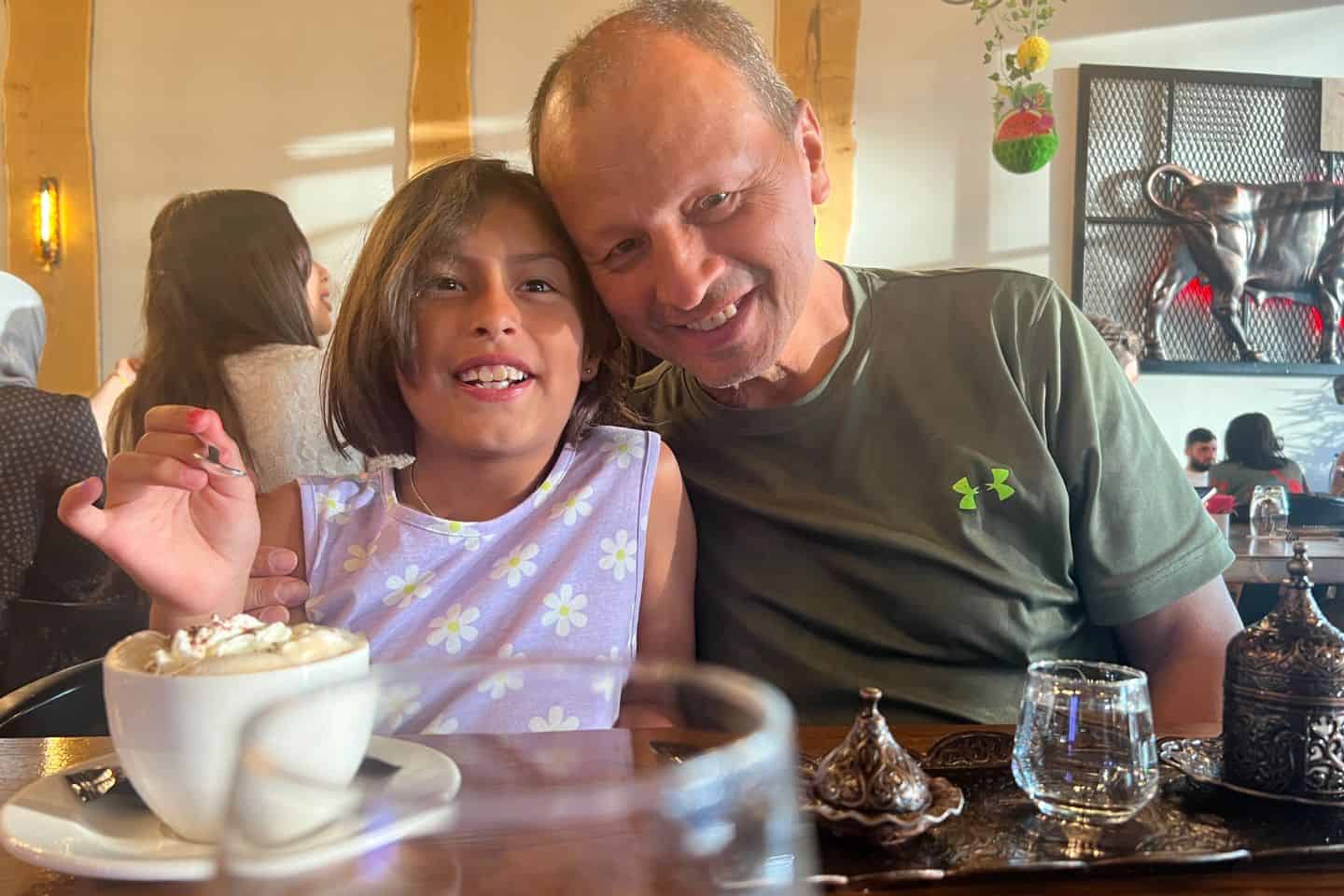 A man and young girl at a coffee shop