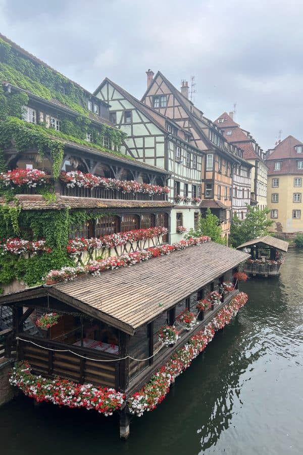 Buildings with colorful flower boxes lining a canal 