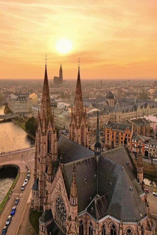 The skyline of a cathedral with a sunset in the background