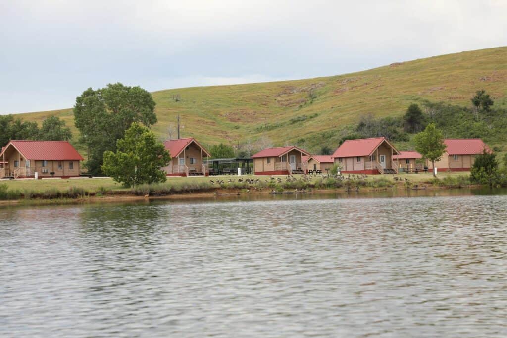 cabins on a lake with mountains in the background