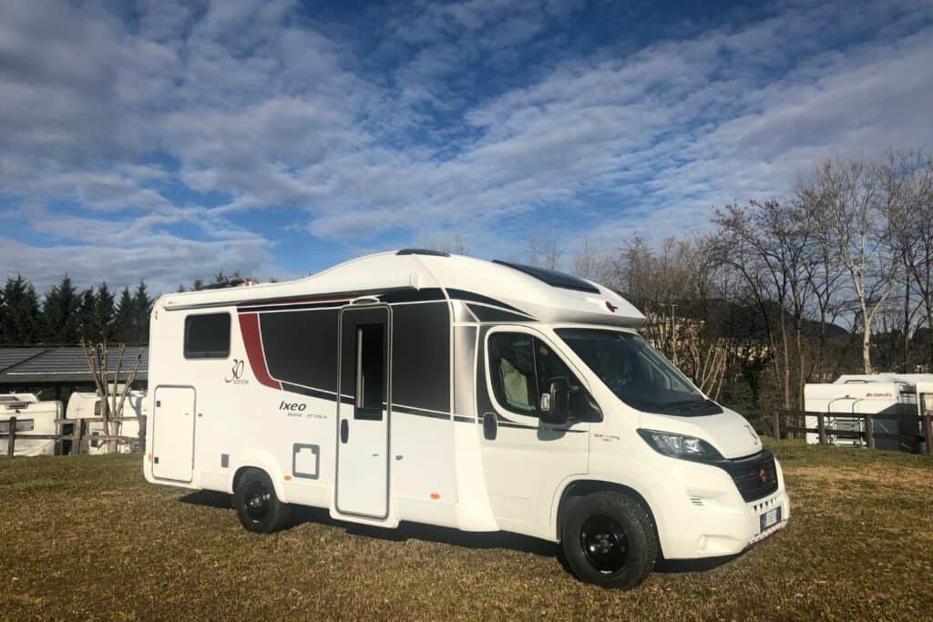 A small motorhome parked in a field