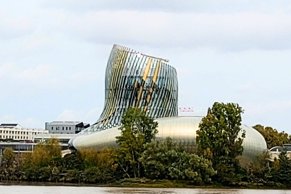 A large, modern building on the river