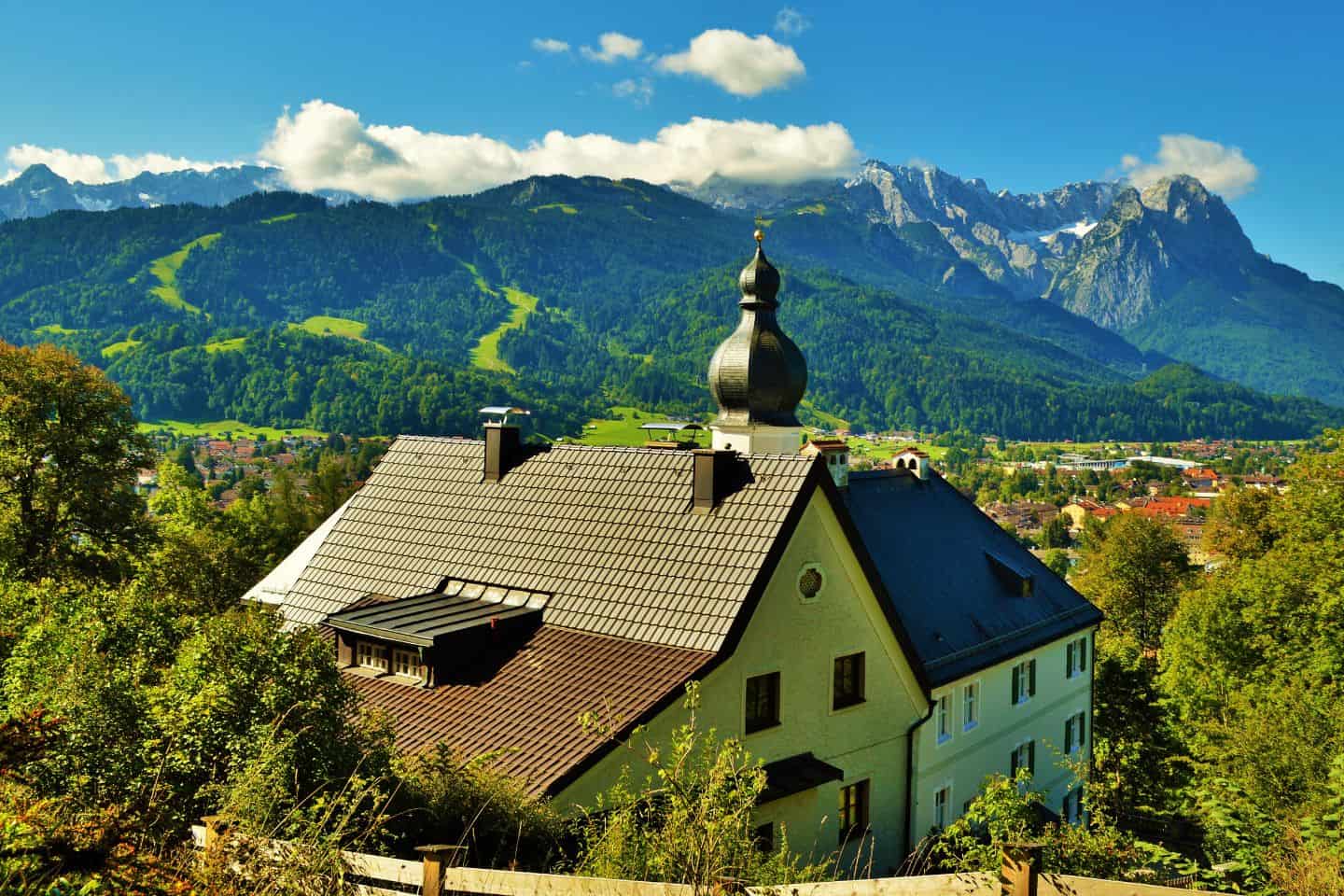 A German style house with mountains in the background