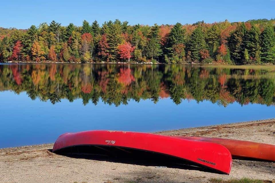 Red canoes turned upside down on a pier 