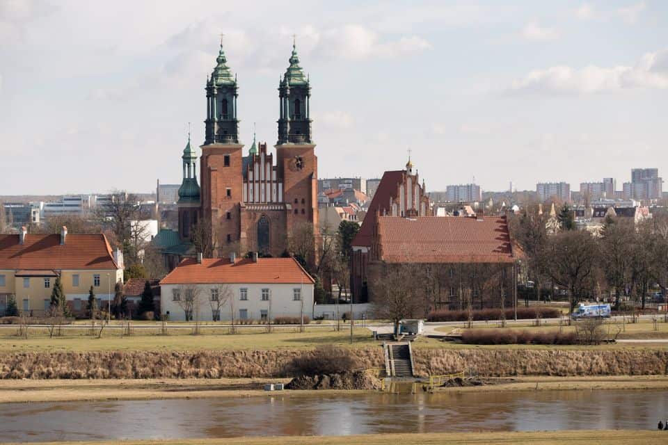 A church with two tours next to a river