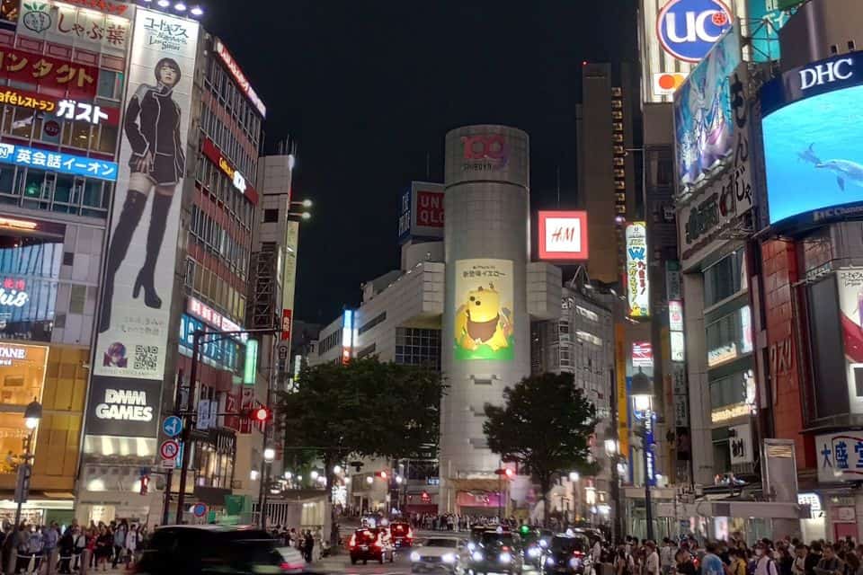 A busy urban street crossing full of lights