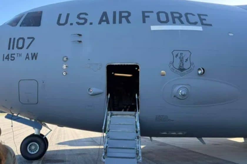A gray military cargo aircraft with US Air Force written on the side and a short staircase leading to the door.