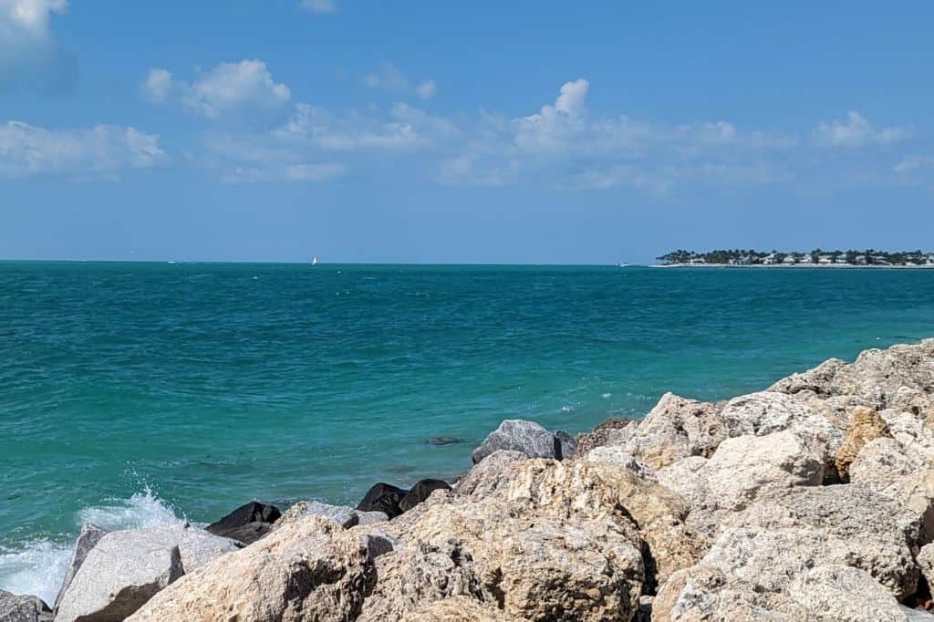turquoise water surrounding the rocky coast of nas key west.