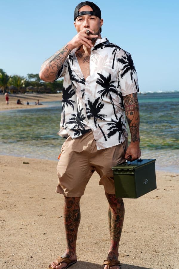 Veteran standing on Sosúa Beach smoking a cigar a