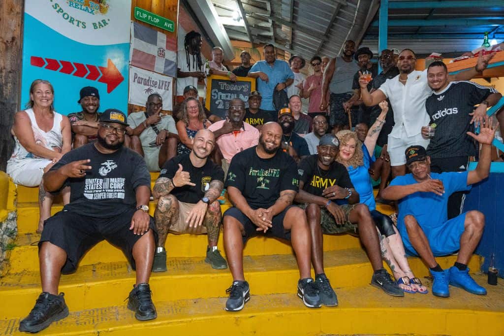 veterans and supporters gathered on yellow steps at a Sosúa event.