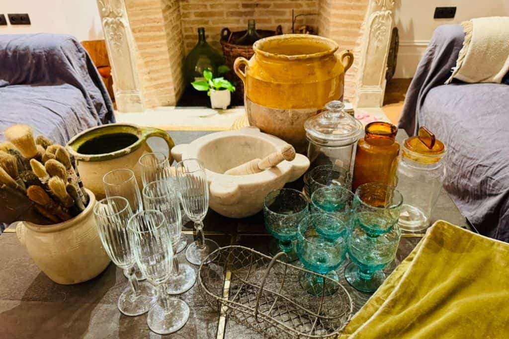 Vintage glassware and French brocante treasures arranged on a table