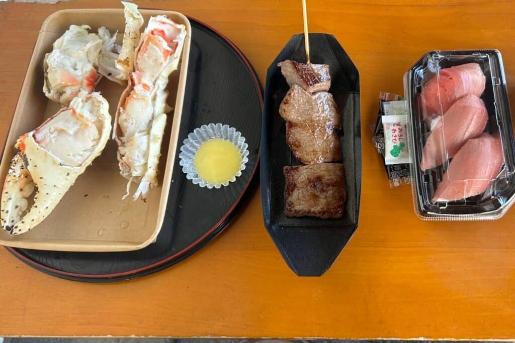 Fresh food at Tsukiji Outer Market, including sushi and skewers of meat