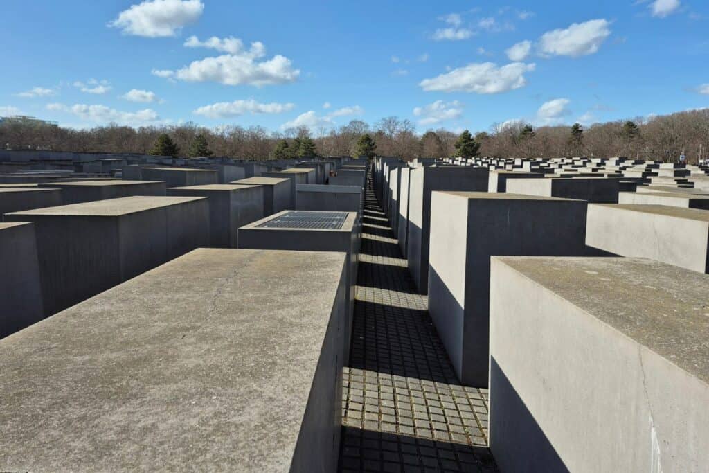 Rows of concrete blocks forming narrow pathways at a memorial site in Berlin