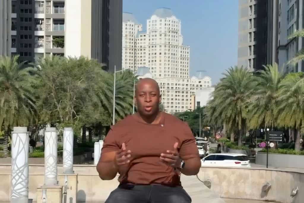 Markeiz recording a video in a modern residential area of Ho Chi Minh City.