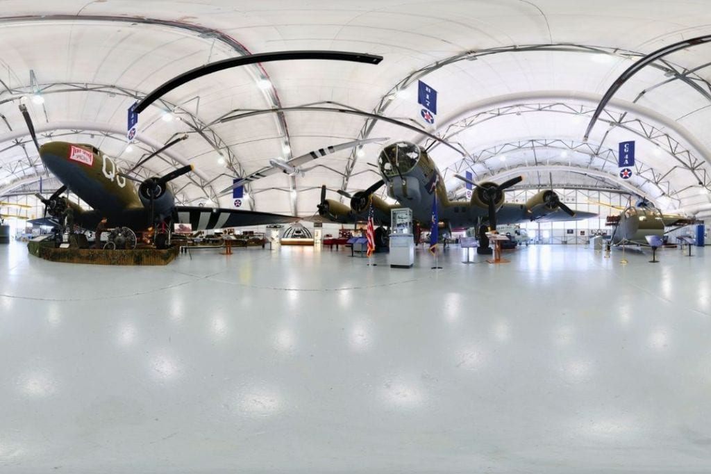 historic military aircraft displayed inside a large hangar