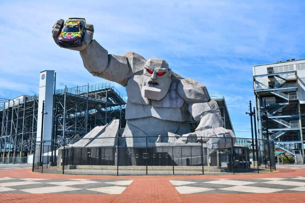 The Monster Monument outside Dover Motor Speedway. The monster holds a NASCAR race car above the entrance plaza.