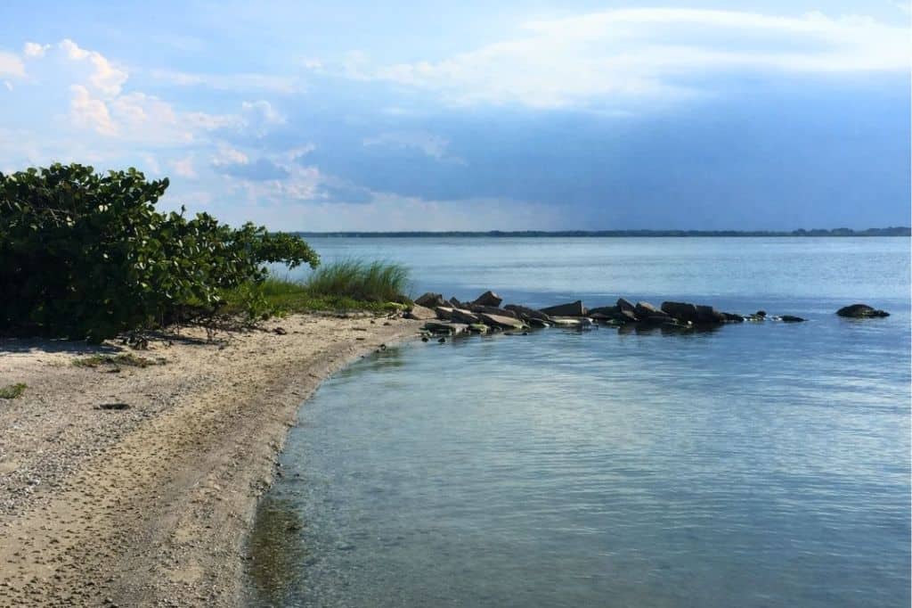 Quiet shoreline and calm water at a small beach