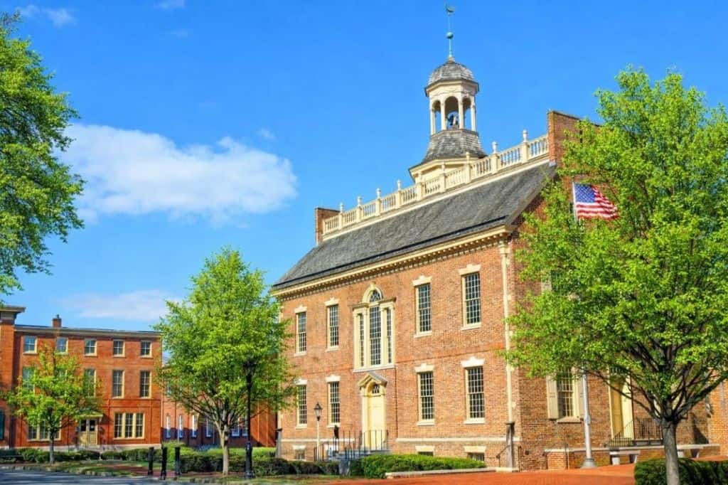 A brick colonial style buiding with a bell tower on top