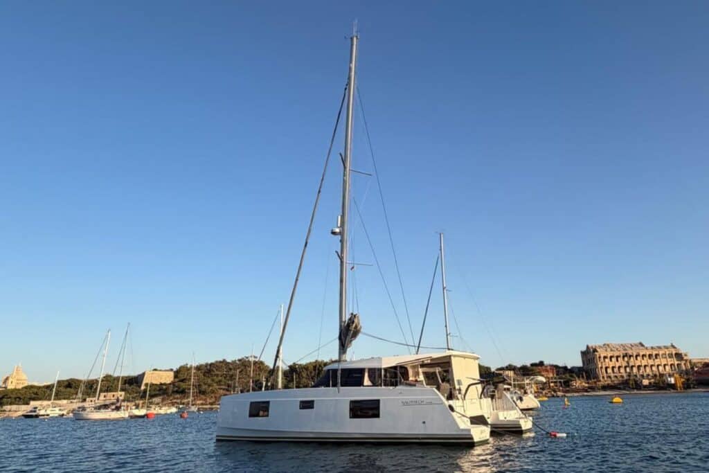 Catamaran anchored near a historic waterfront