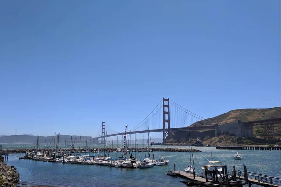 Sailboats docked at Travis Marina with the Golden Gate Bridge behind them