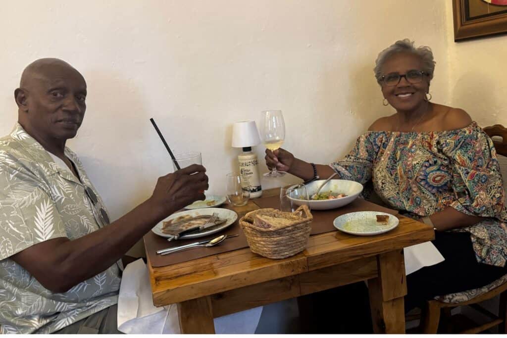 A couple having dinner at a small wooden table