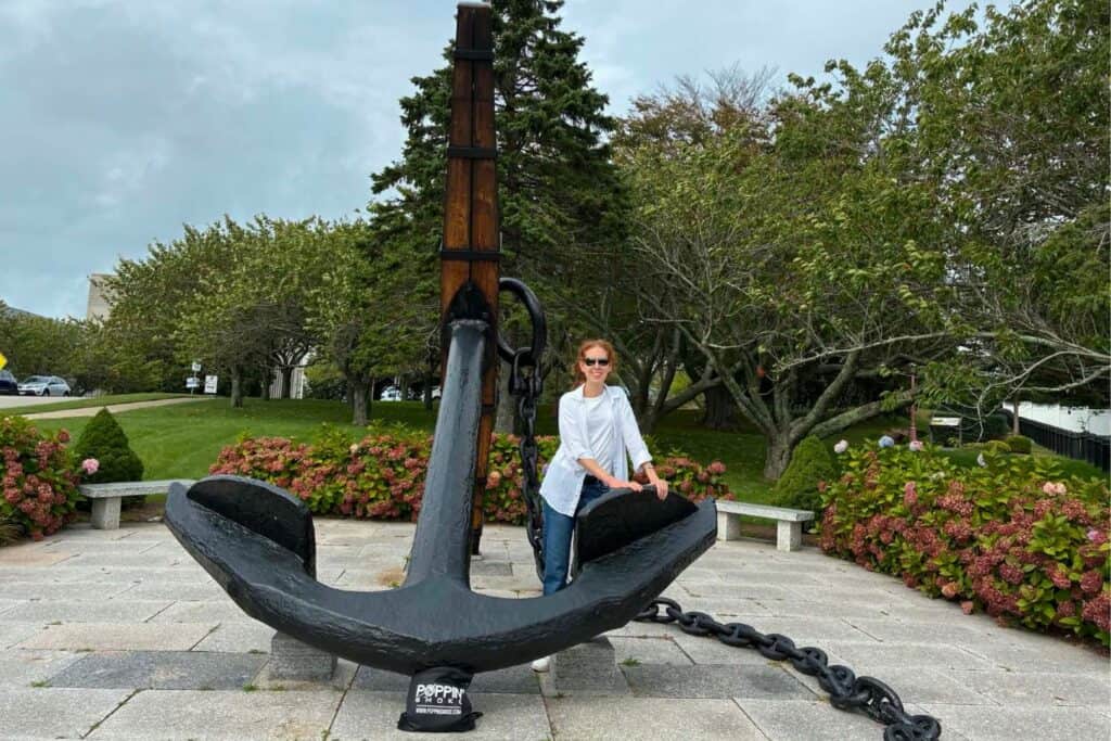 Stephanie standing beside a massive black anchor displayed outside the Naval War College Museum