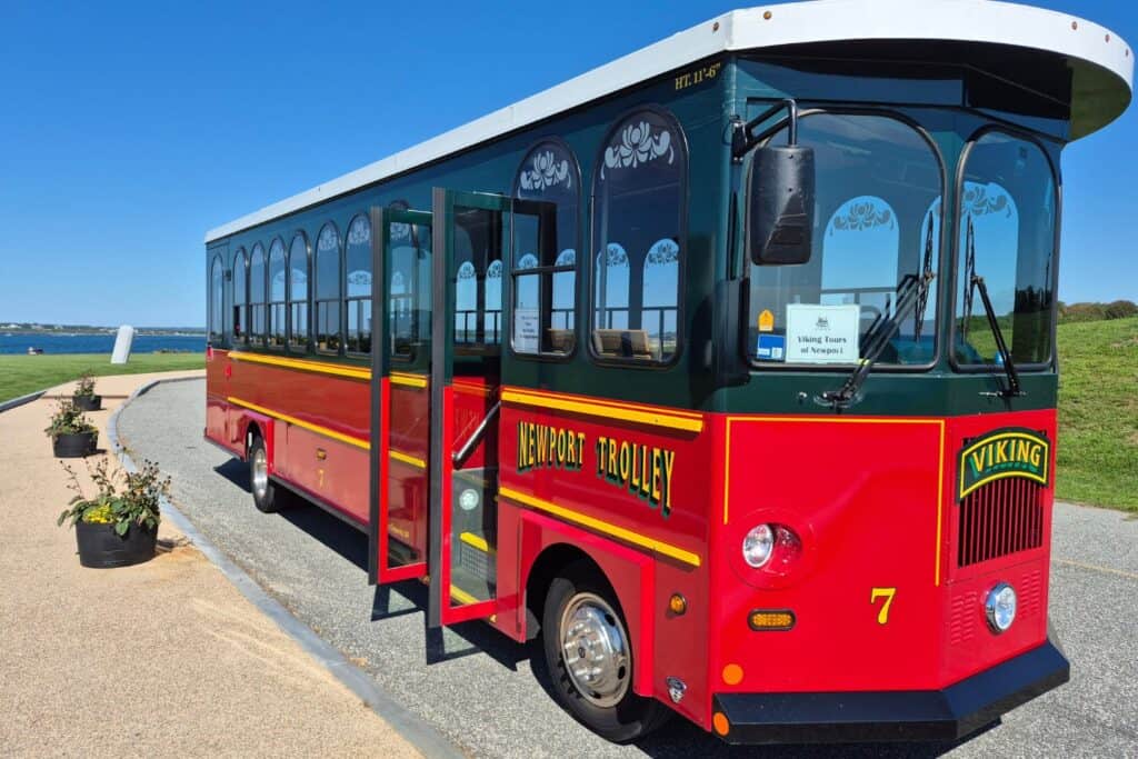 Red Newport sightseeing trolley parked near the waterfront