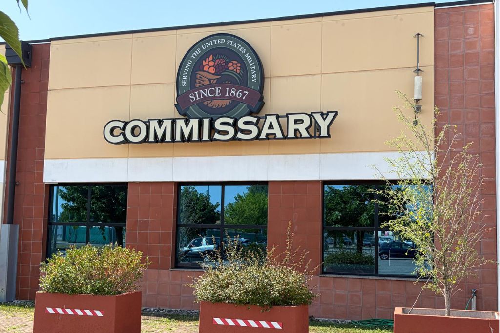 Exterior of the Vicenza commissary with a large Commissary sign above the entrance