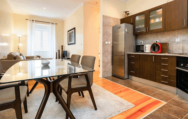 The modern kitchen and dining area of our Airbnb in Lisbon.