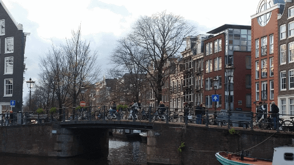 Cyclists riding over a bridge in Amsterdam