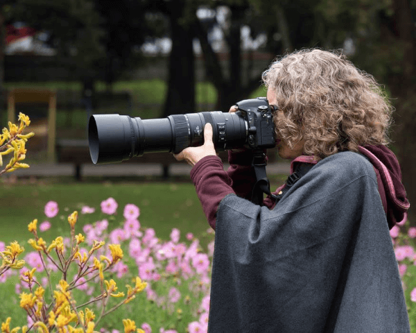 Angie using a long lens to take photographs