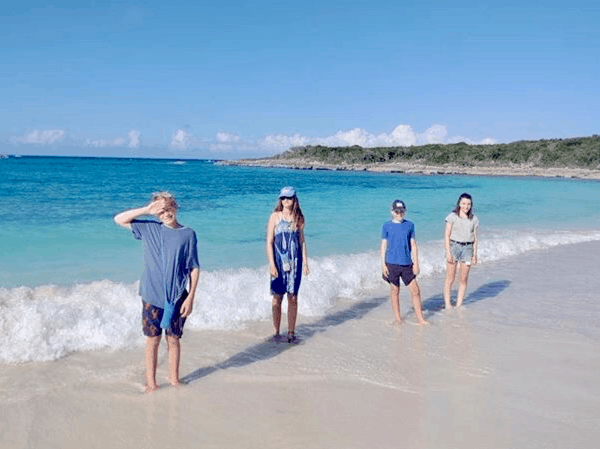 Four kids standing on a beach in the Bahamas