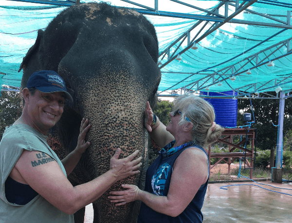 Ron and Colleen rubbing an elephant's trunk